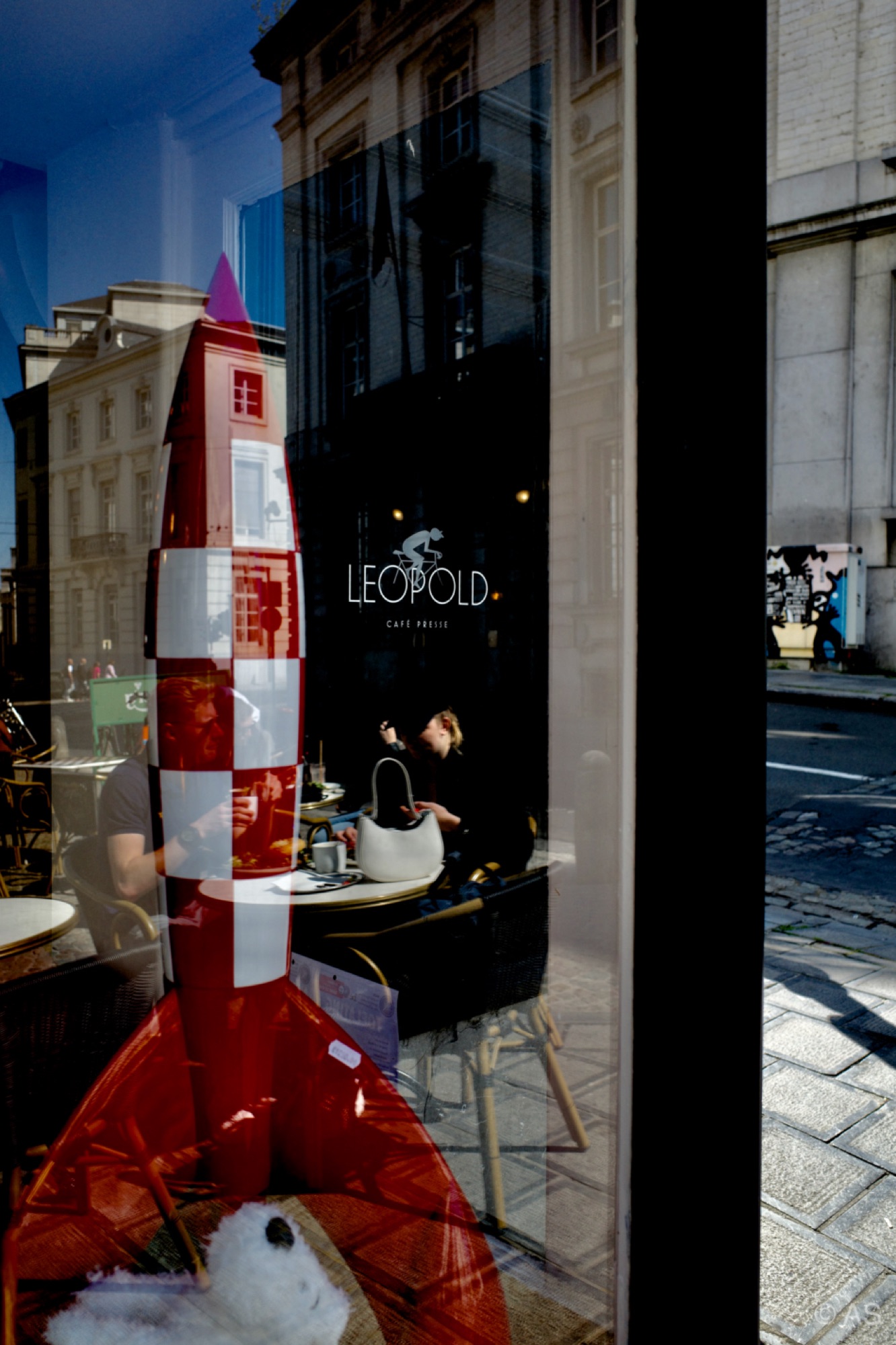 Reflection in a Copenhagen caf&eacute; window with red and white flags